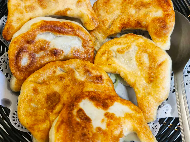 Golden pan-fried dumplings with savory filling at New Ocean Restaurant, a Chinese Restaurant in Newark